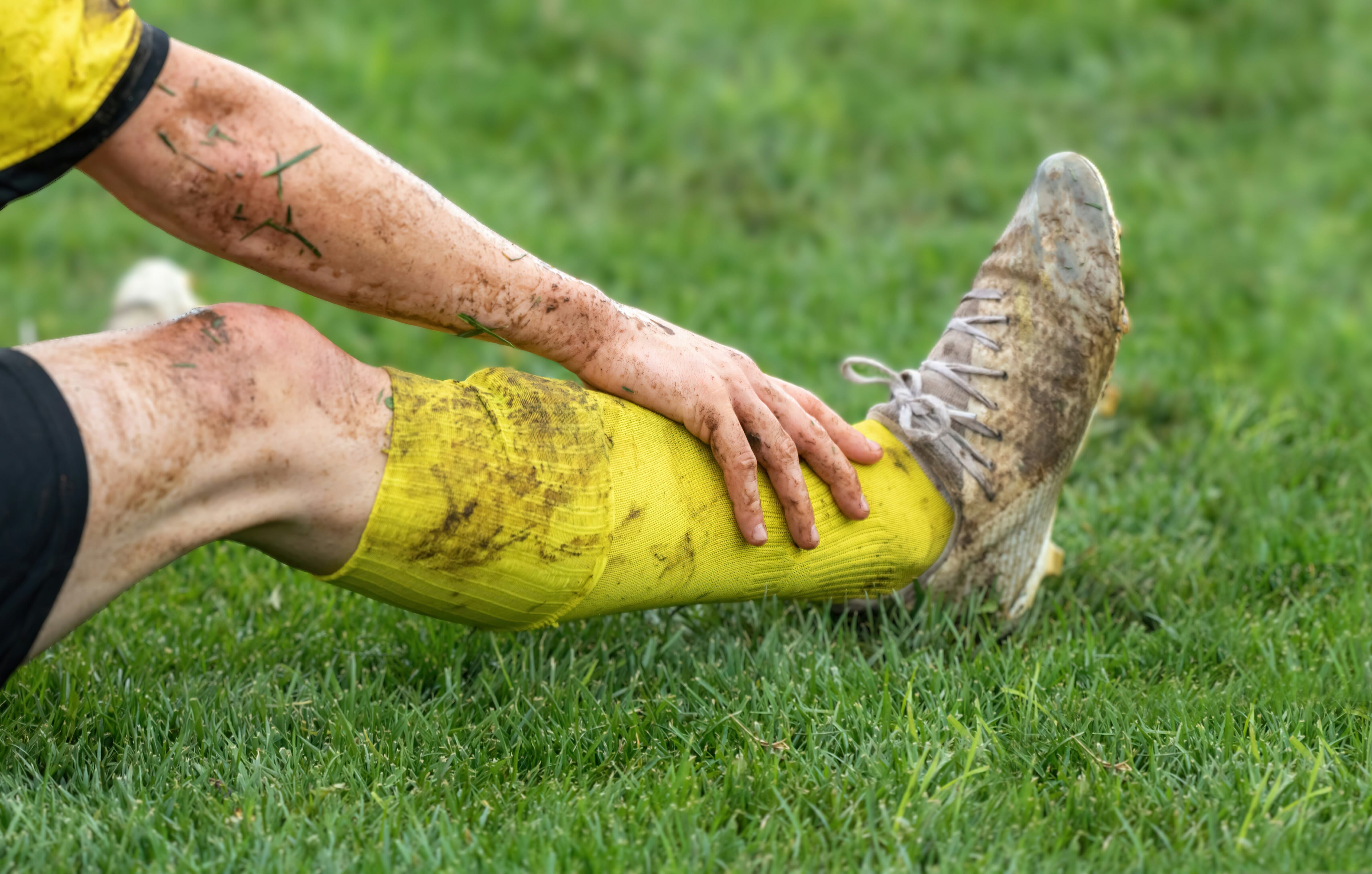 soccer-football-concept-injured-footballer-lay-down-field